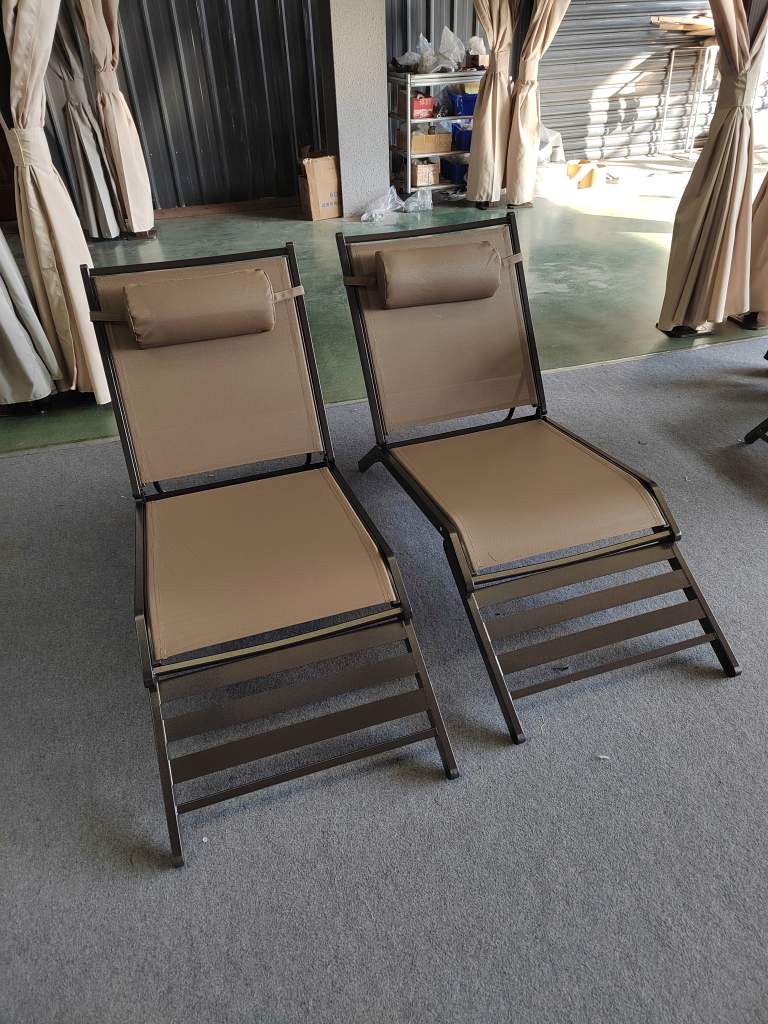 Two beige lounge chairs with metal frames, ideal for relaxation. perfect for sale at wholesale or custom logo options.