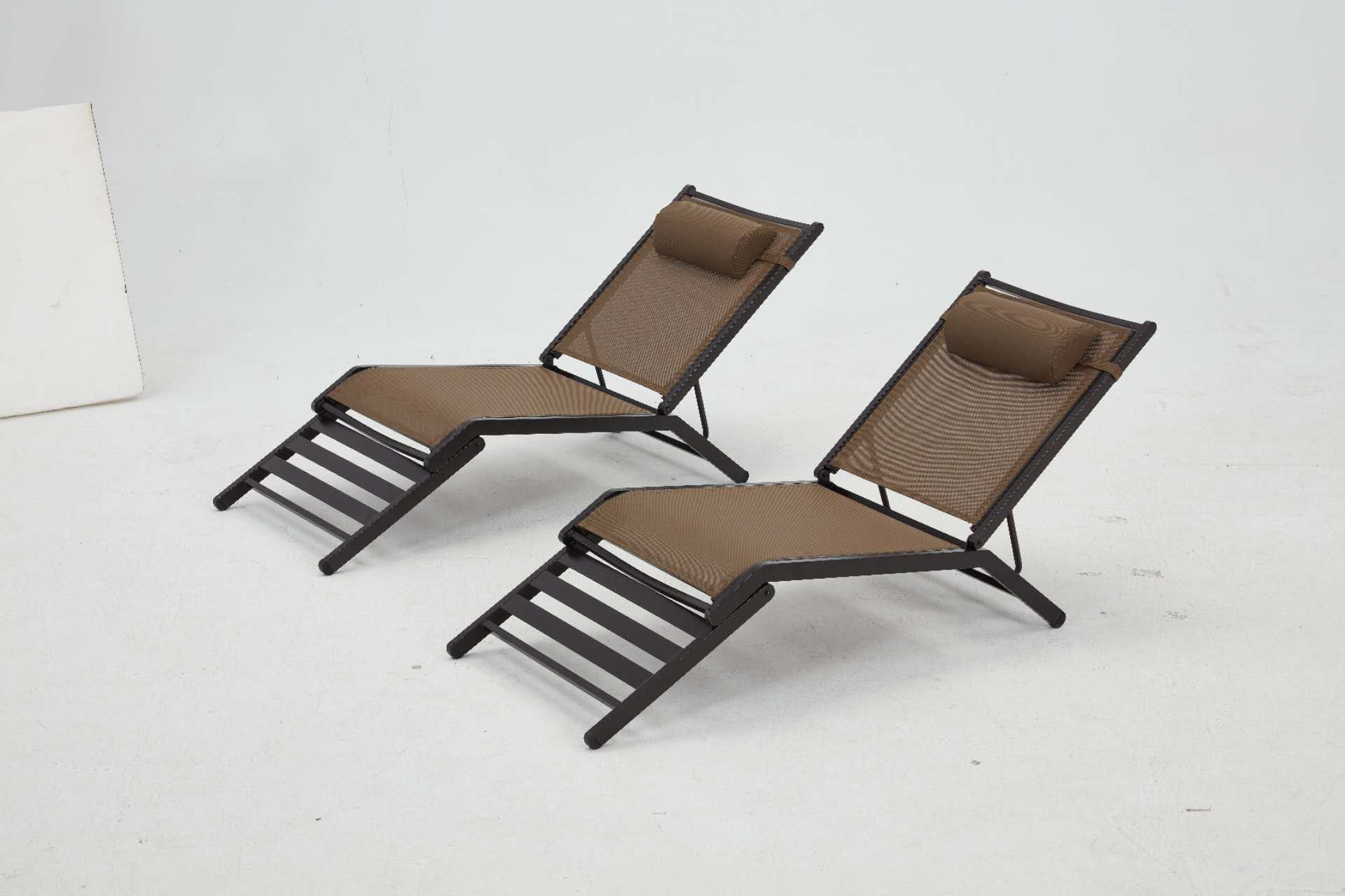 Two brown lounge chairs with reclining feature, perfect for relaxation. ideal for outdoor spaces or indoor use.