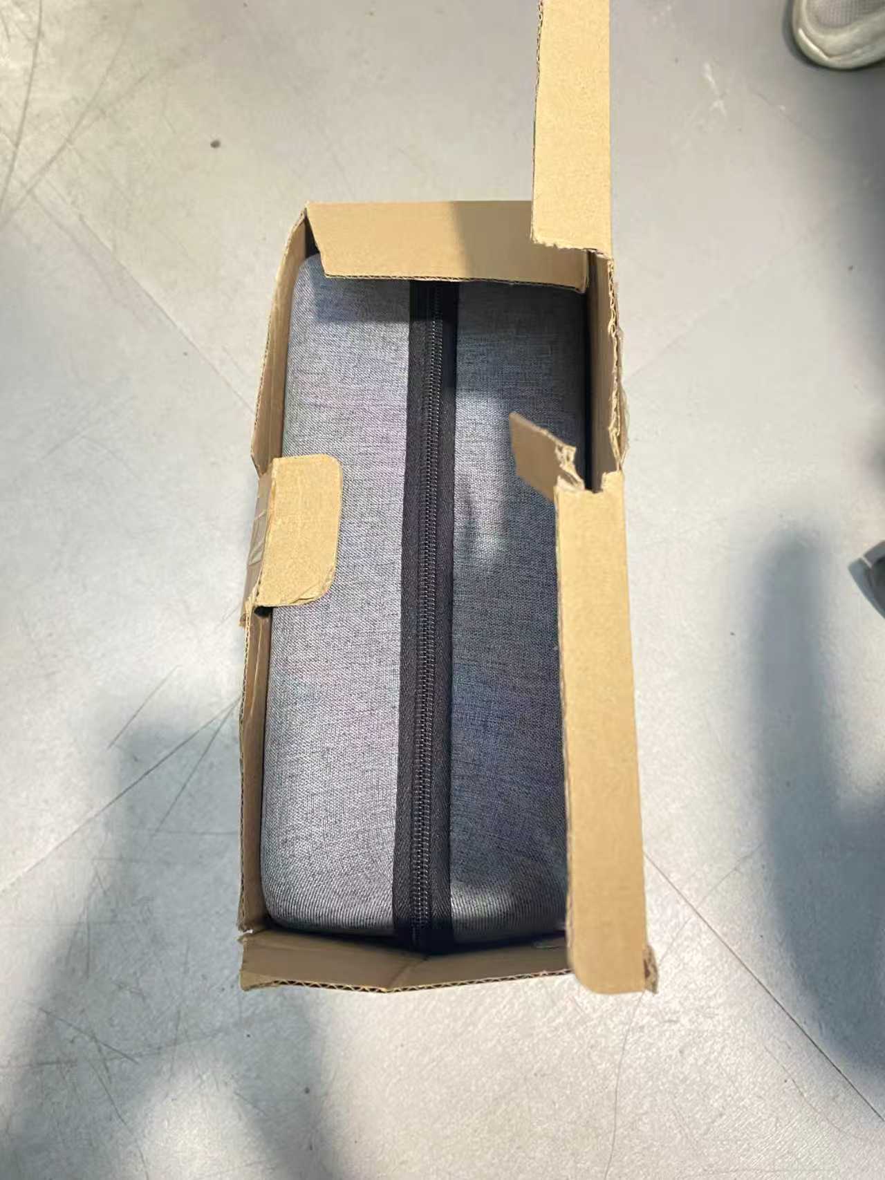 Portable high-pressure washer with 110-piece clearance kit in gray fabric case, ready for shipping.